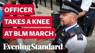 Police Officer takes a knee outside Downing Street at Black Lives Matter march in London