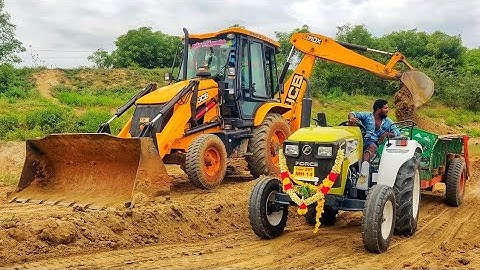 JCB 3dx backhoe loading mud in Sonalika and powertrack