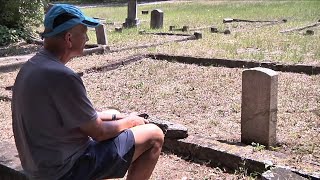 Man tends to neglected veteran gravestones