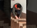 Skilled Worker Installing Wooden Floor With Herringbone Pattern