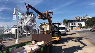 Putting the motors in the charter boat 100 Proof in Destin, FL