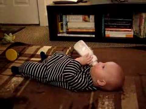 baby holding a bottle