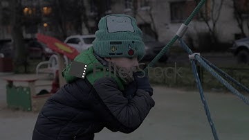 Boy playing outdoor and climbing rope web