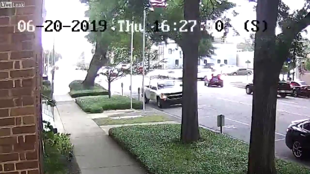 Man walks away after tree falls on car