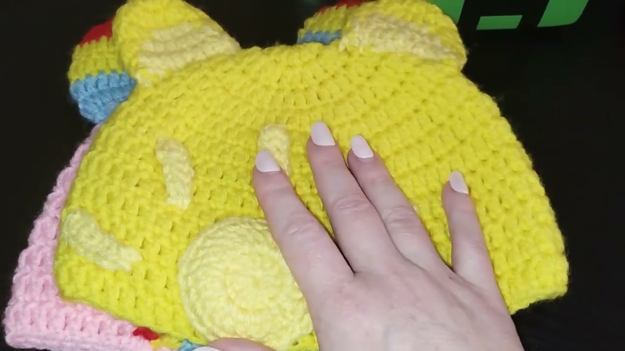 Two crochet Care Bear theme beanies.