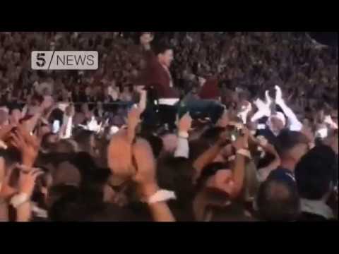 Coldplay fan crowdsurfs in a wheelchair and joins Chris Martin on stage