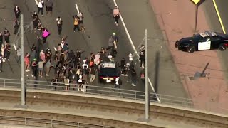Protester falls off police car at Black Lives Matter protest