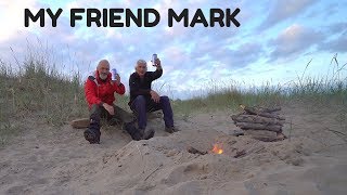 Beautiful sunset over hills and beach and wild camping in winter storm