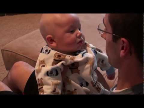 Son Sitting on Father's Lap Laughing