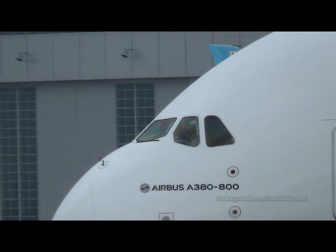 Friendly waving pilot at delivery of Emirates A380 A6-EEV takeoff to Berlin ILA 2014