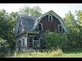 Abandoned gambrel-style farmhouse full of junk