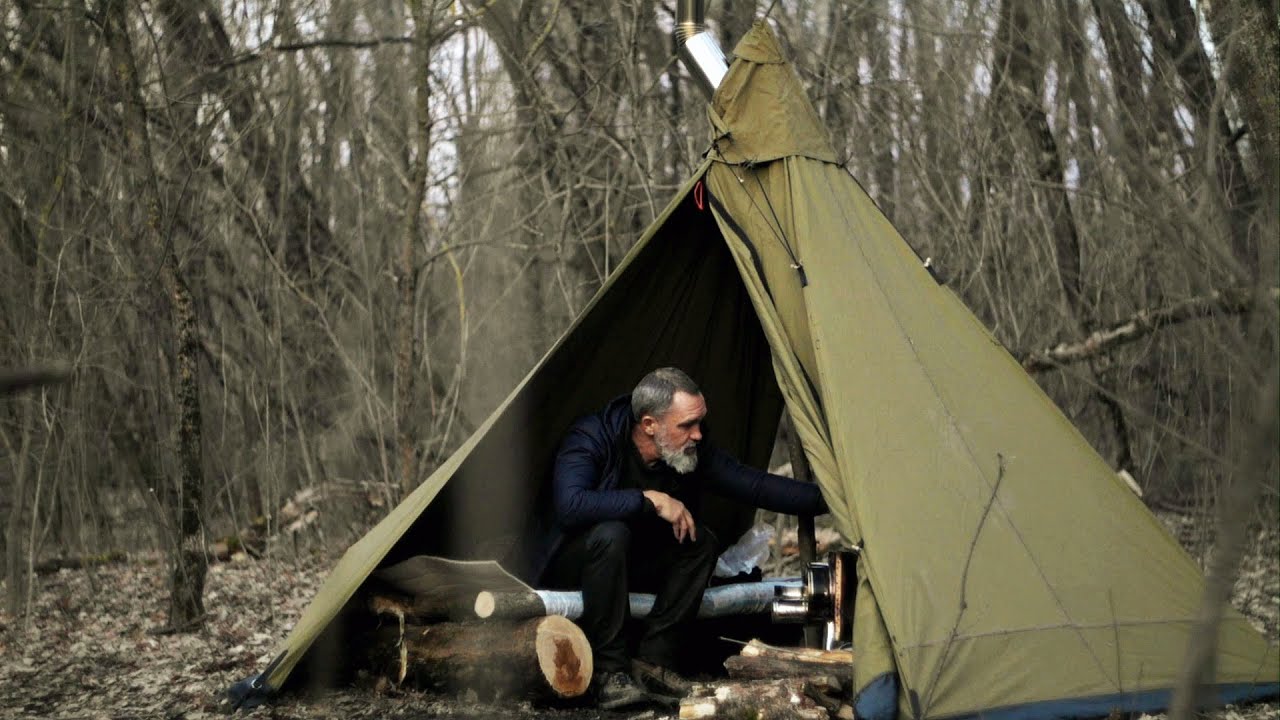 Winter camping with a homemade hot tent, wood-burning stove, food in the oven