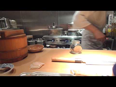 Kevin Cory prepares live scallop nigirizushi/sush....