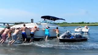 Boat Stuck on Sand Getting Towed Out