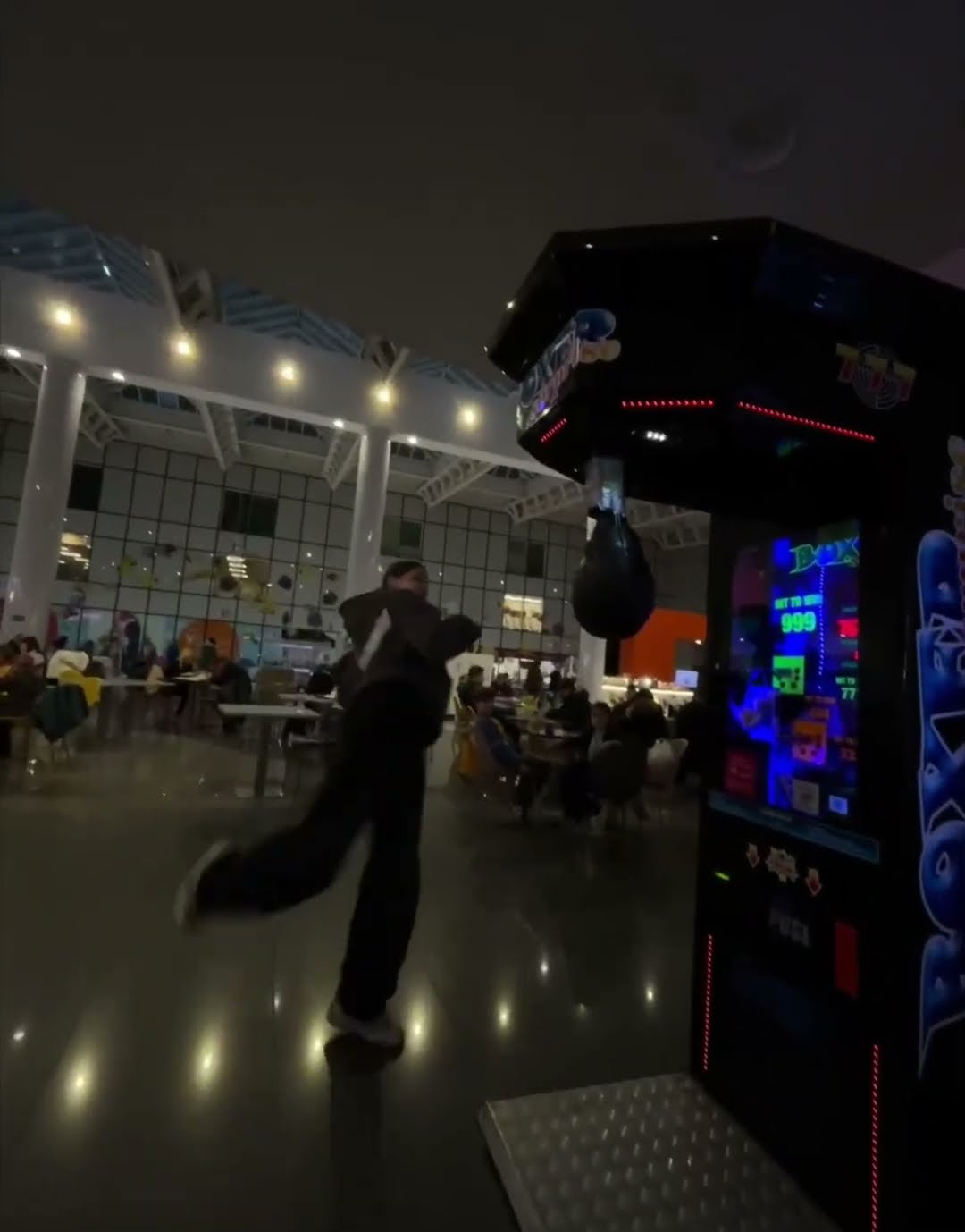 Girl Falls While Kicking Punching Bag on Arcade Machine