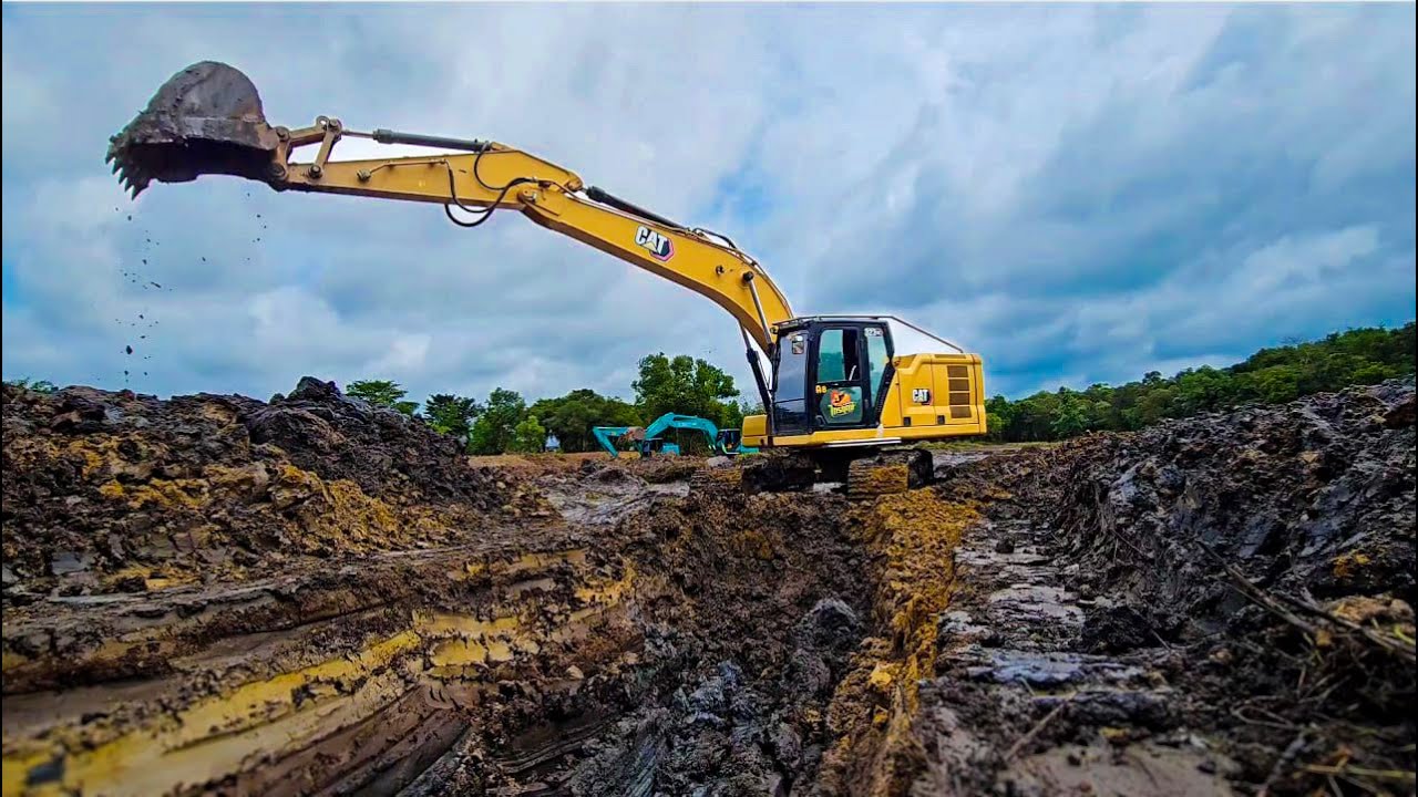 Excavation in Progress: CAT Excavator at a Muddy Construction Site