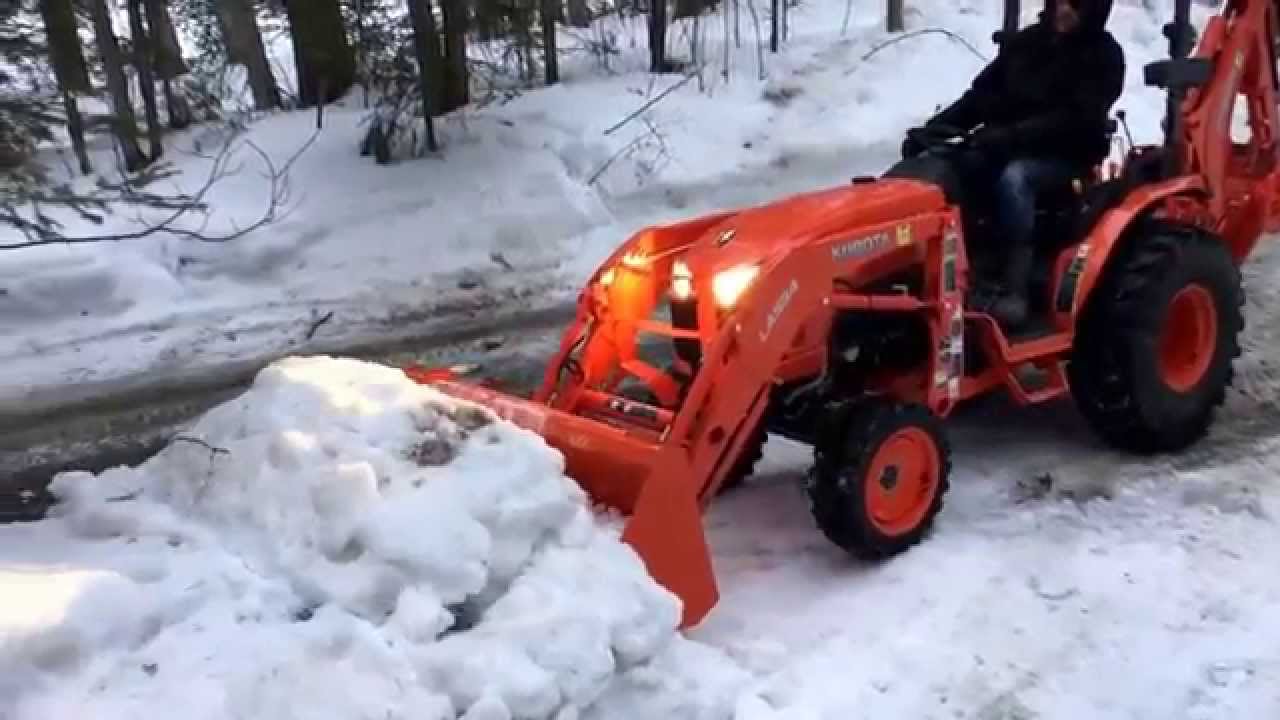 Kubota B2650 with LA534 loader and backhoe moving lots of snow without