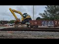 How does an excavator board a train?