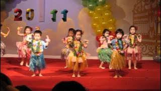 Sarah hula dances at her pre-school's graduation ceremony