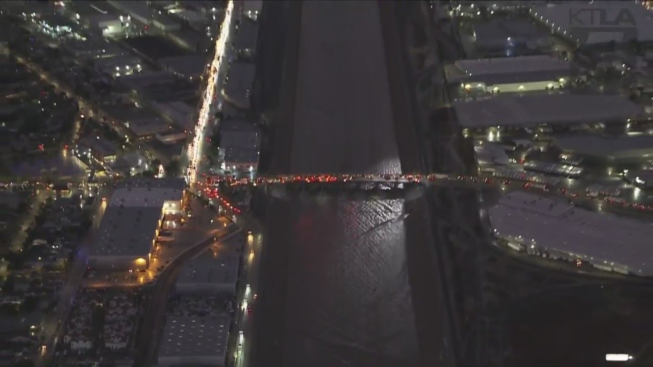Crews rescue man swept away into the Los Angeles River - YouTube