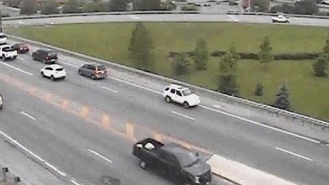 Car escapes traffic by driving backwards, then keeps going