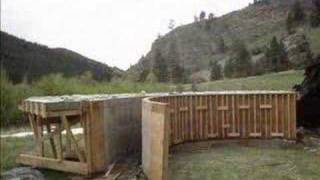 Construction of a reinforced concrete arch bridge with cultured stone facing.