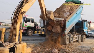 Dump Truck Unloading Rock Not Out Assisted by Excavator