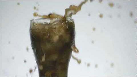 Dropping ice in a coke glass.