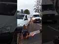 Van nearly hits eco-protester as it mounts pavement to get past