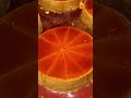 A caramel cake that is being cut into several pieces using a special sharp tool