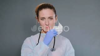 Exhausted Doctor in Protective Coat Takes Off Mask and Cap | Stock Footage - Envato elements