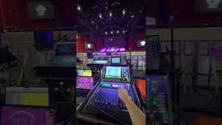 Controlling an arena stage lighting rig from an audio mixing console.