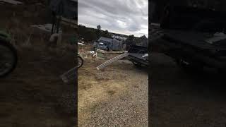 Guy rides dirt bike up ramp onto back of pickup truck but ramp hits his face