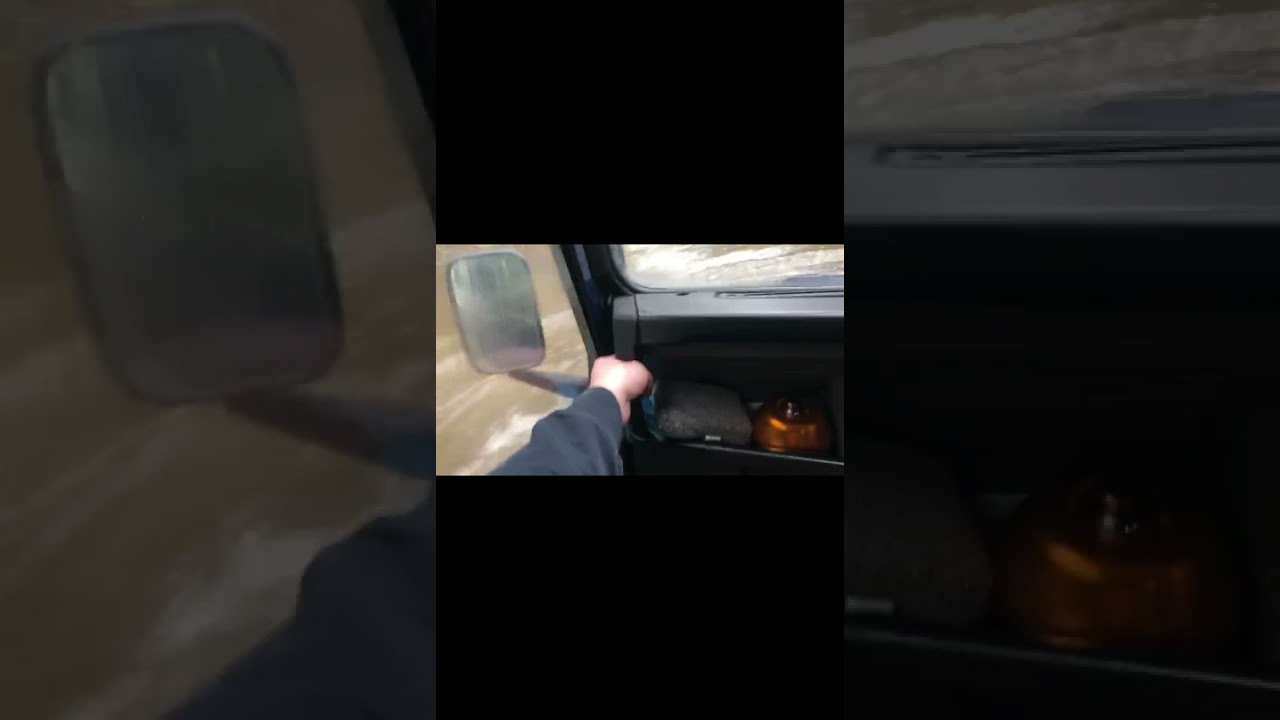 Land Rover Defender going through deep water crossing, floating