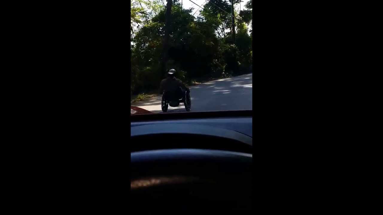 Man in wheel chair going down Mt Rosser jamaica