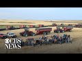 After he suffered a heart attack, 60 neighbors showed up to help a local farmer