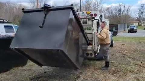 Ram 5500 with 8 yard Curbtender dumping a empty 4 yard dumpster