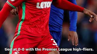 Renato sanches passes to a hoarding board during swansea's game at chelsea