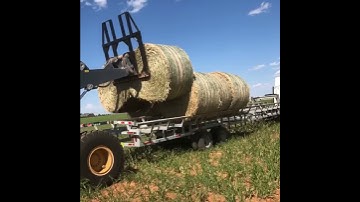 Loading round bales of hay