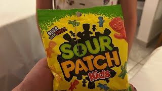 Trying sour patch kids in Greece