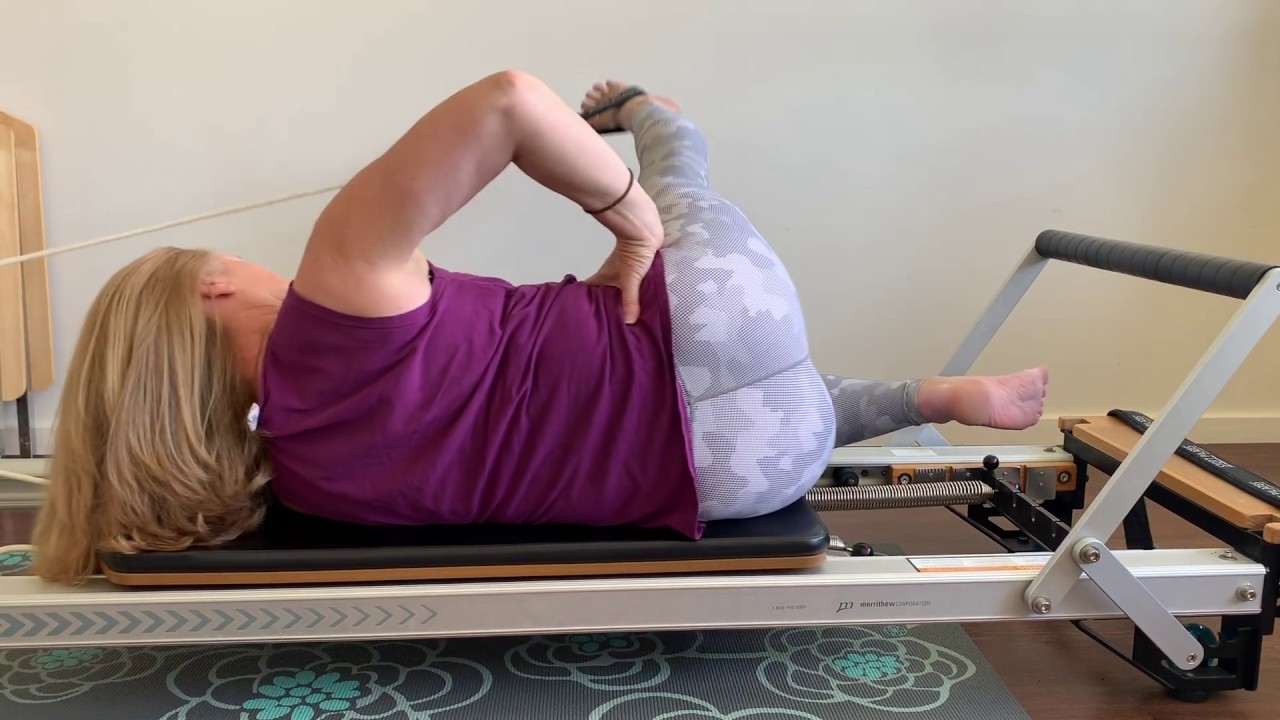 Reformer side lying feet in straps 1