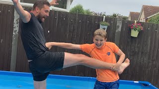 Freezing cold swimming pool wrestling match, dad vs son