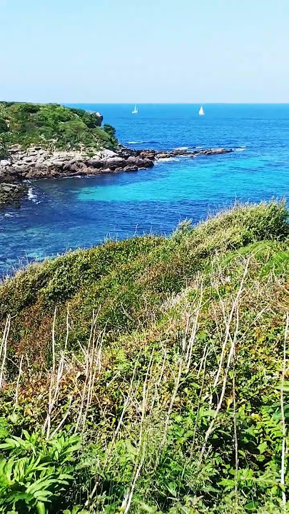 Hiking next to a gorgeous coast with rocky Islands in Northern Spain