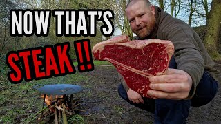 TBONE STEAK cooked on petromax fire bowl over a camp fire.