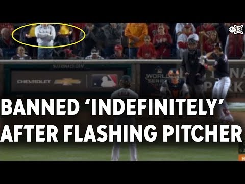 Women flash pitcher during Game 5 of World Series