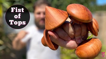 Turning a fist of spinning tops