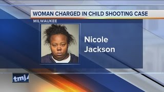 Woman charged in child shooting case