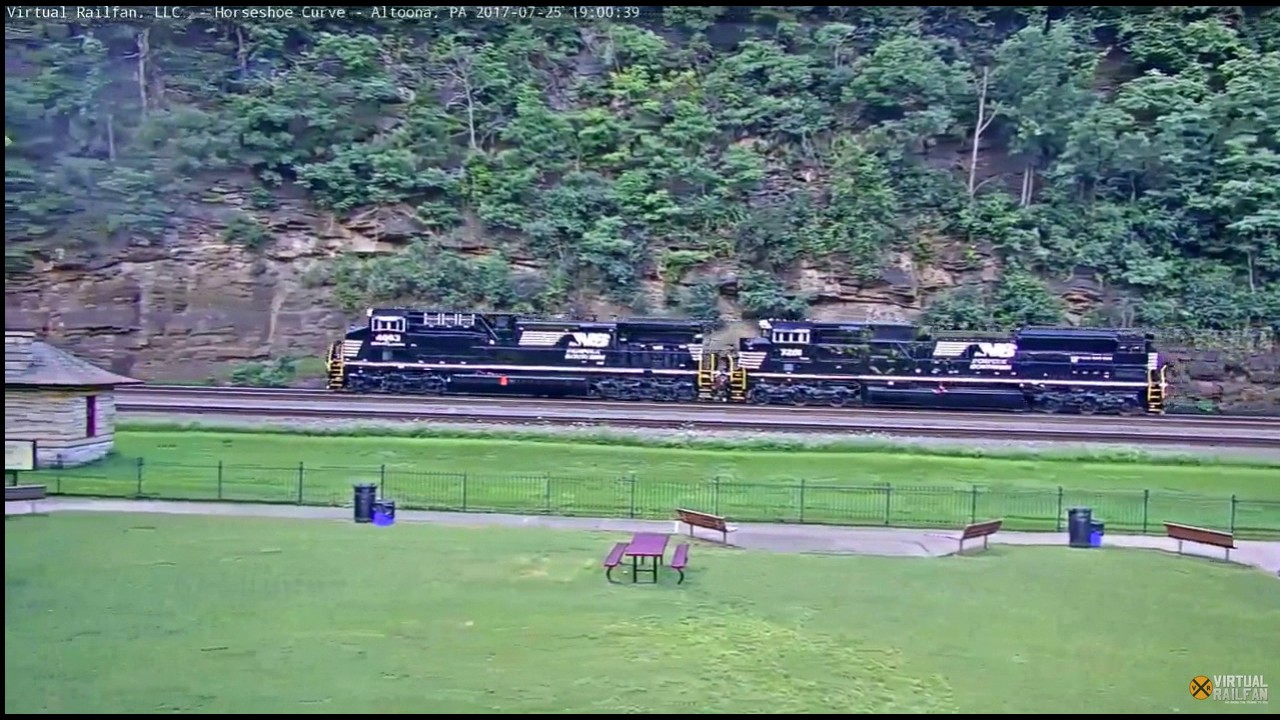 Horseshoe Curve Cam with two nice engines going west with a Railfan
