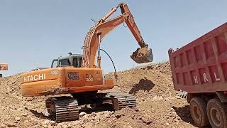 Hitachi zaxis 200 Excavator loading gravel material on the howo dupmtruck.