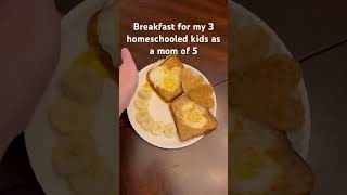 Toast and eggs with heart shaped cutouts, served with a banana smile homeschool breakfastideas